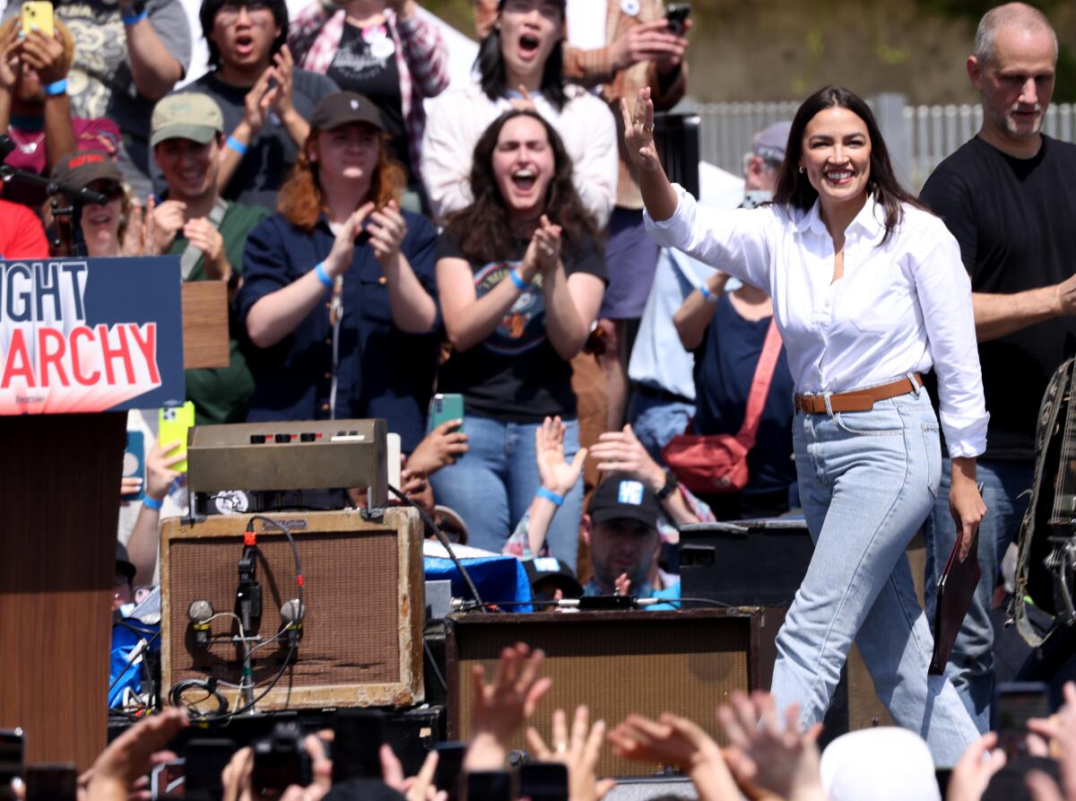 Rep. Alexandria Ocasio-Cortez acknowledges the crowd at a rally in Los Angeles.