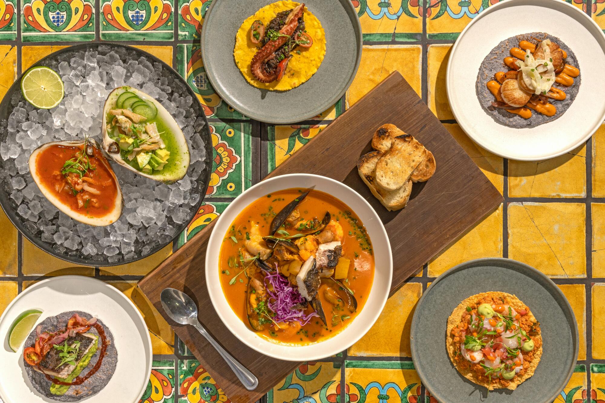 Left to right: fish taco, almeja preparada, octopus taco, scallop taco, kanpachi tostada and seafood stew at Holbox.