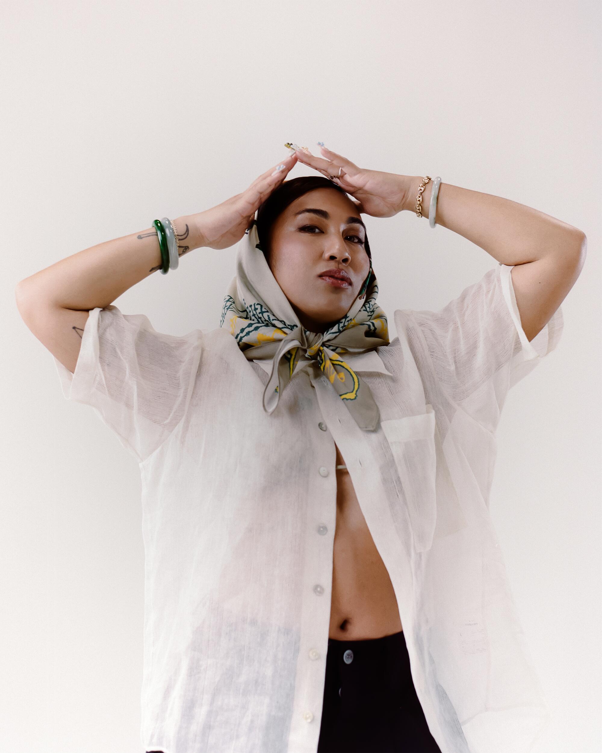 Micah wears Ballads Bobby Glenn bandanna, Maaari Pina button-up, Art Community Anorak jorts, vintage Fendi sunglasses from