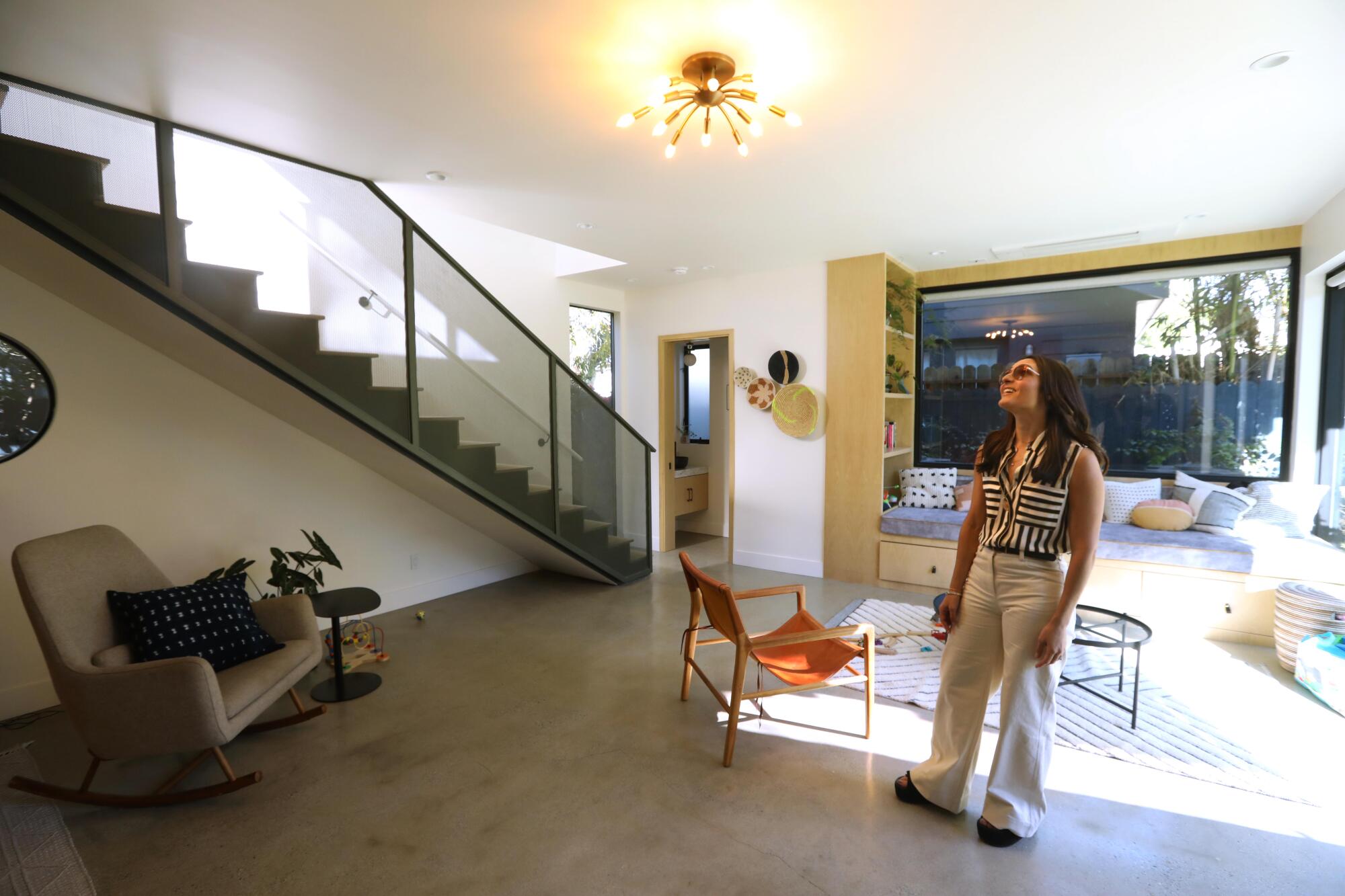 Marina Martos Dabel stands in the middle of the living room of her ADU.