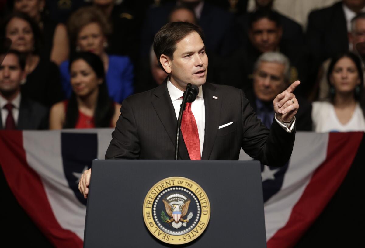 A man speaks at a lectern.