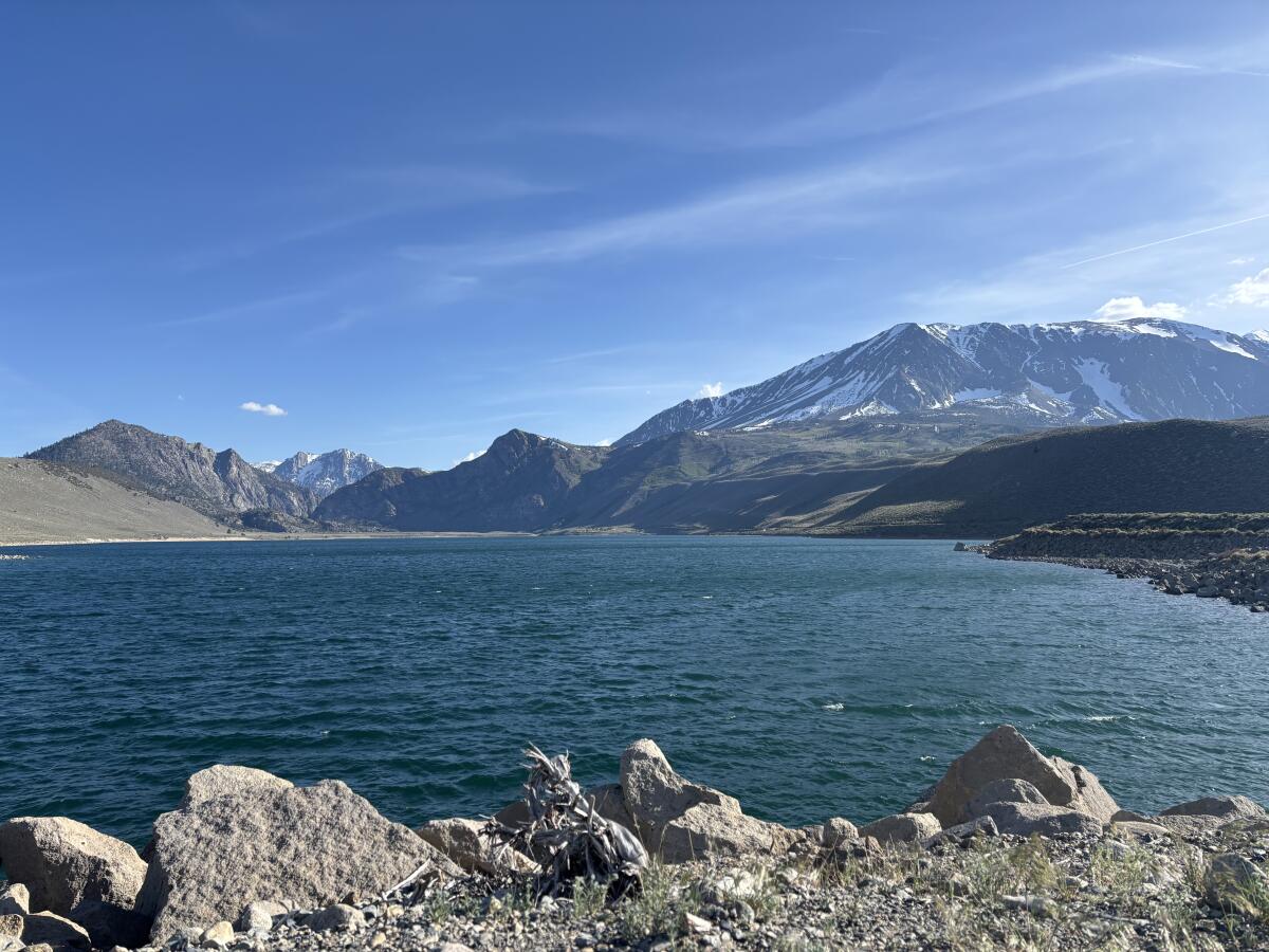 A body of water with mountains in the background.