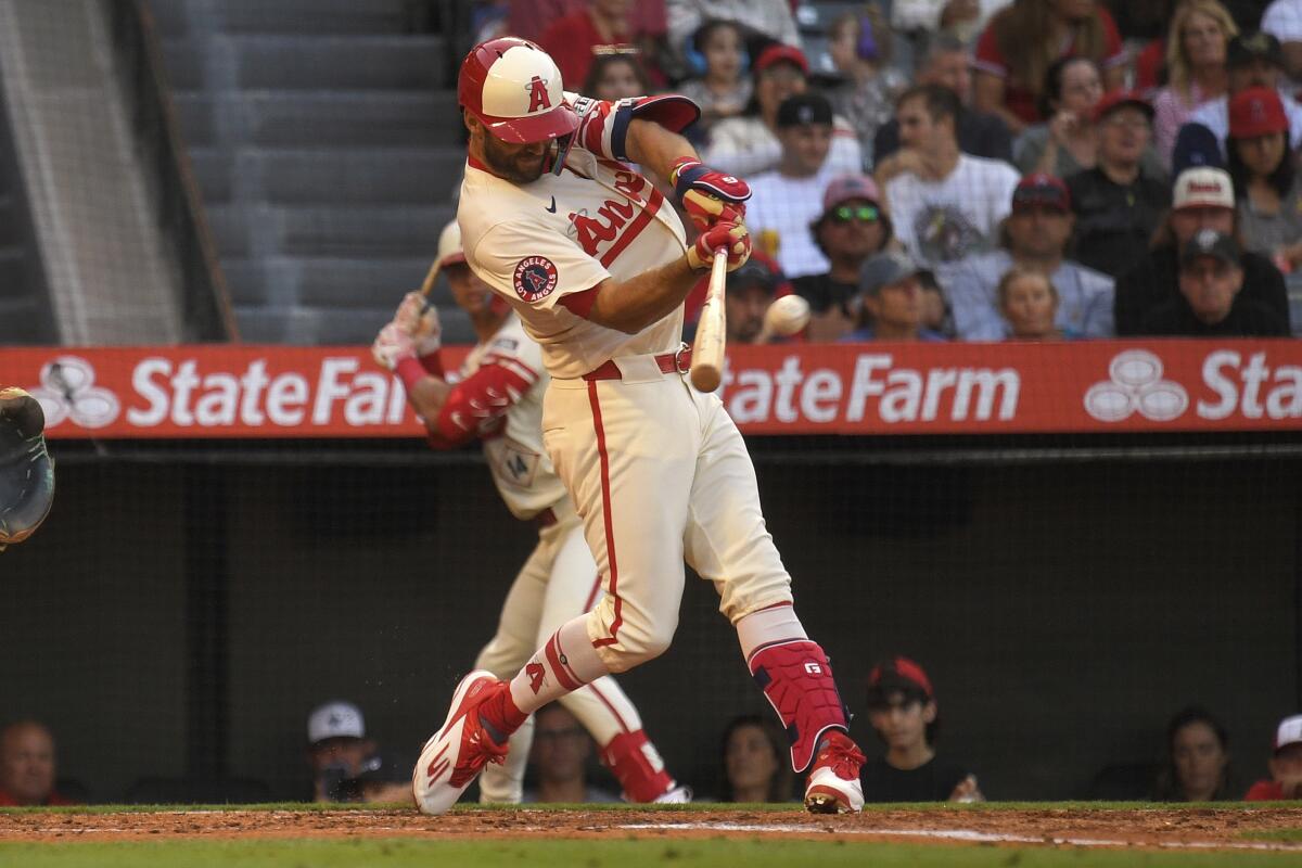 Chris Taylor hits a solo home run during the second inning of the Angels' 8-6 win over the Seattle Mariners.