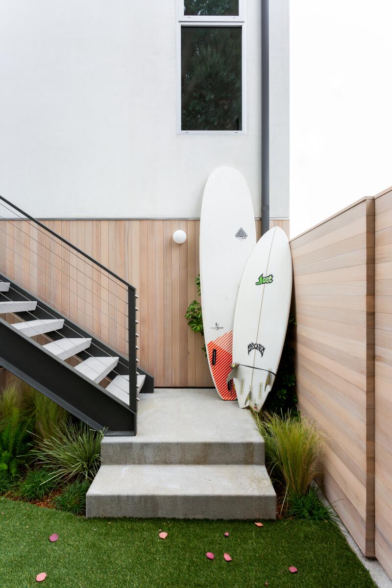 Surfboards rest on a stairway