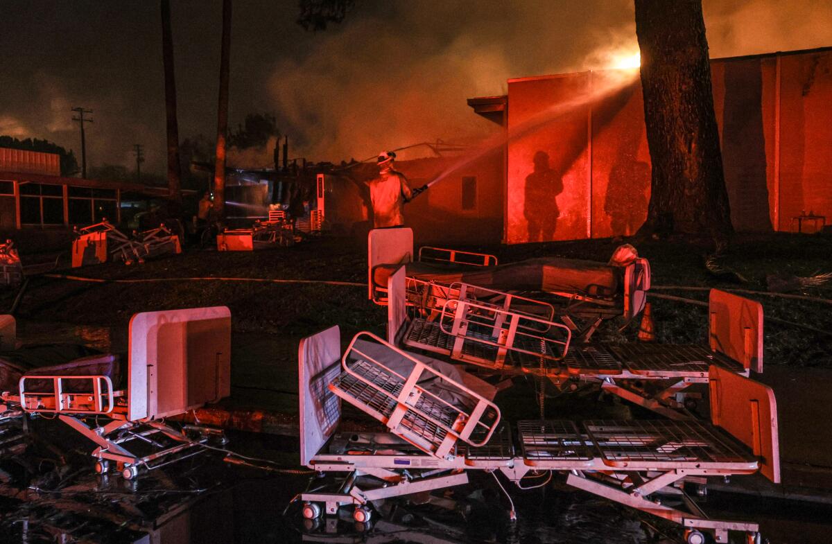 Firefighters douse the last flames hours after Two Palms Care Center was evacuated on Jan. 8.