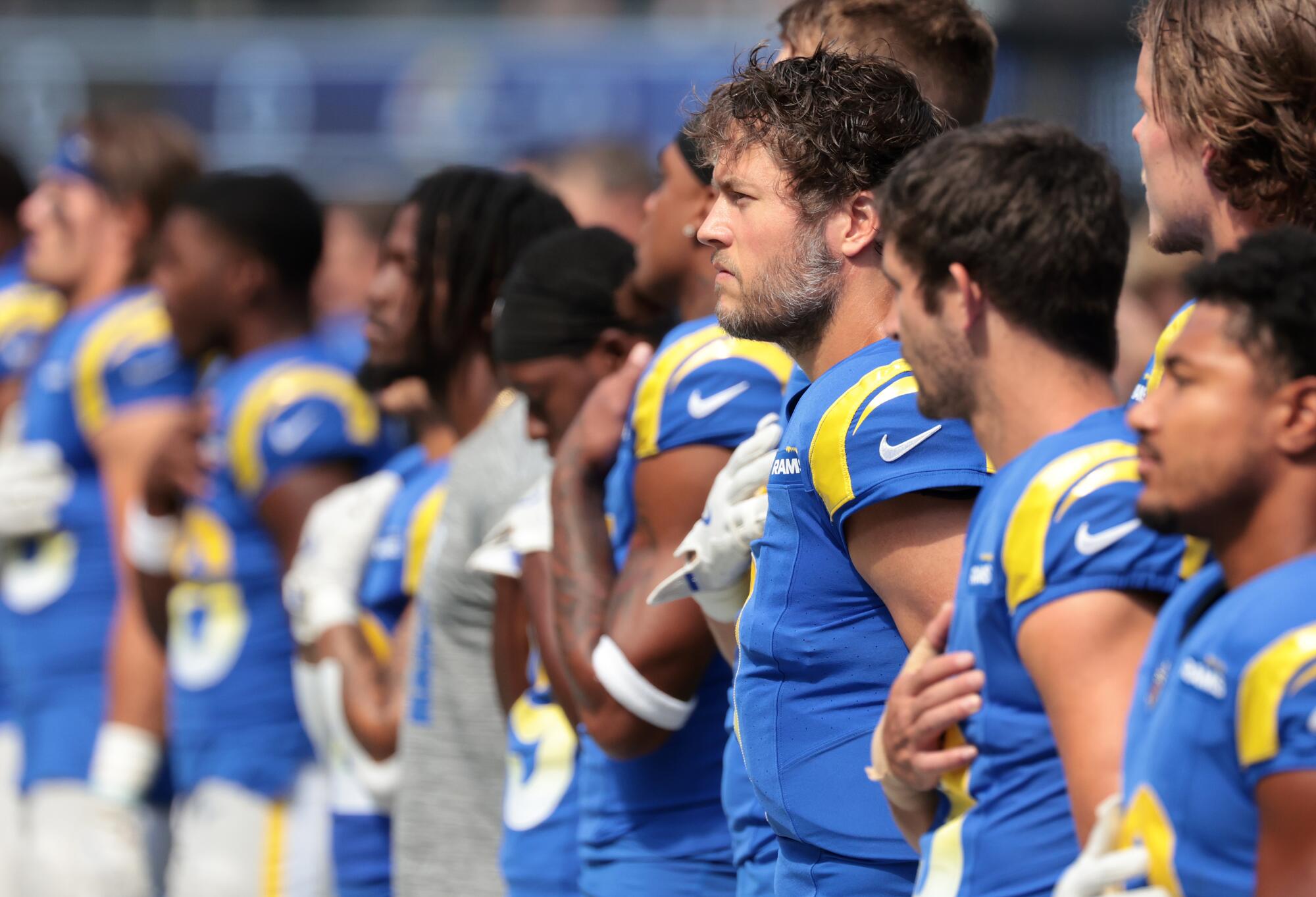 Rams quarterback Matthew Stafford listens to the national anthem with his teammates before a game in October.