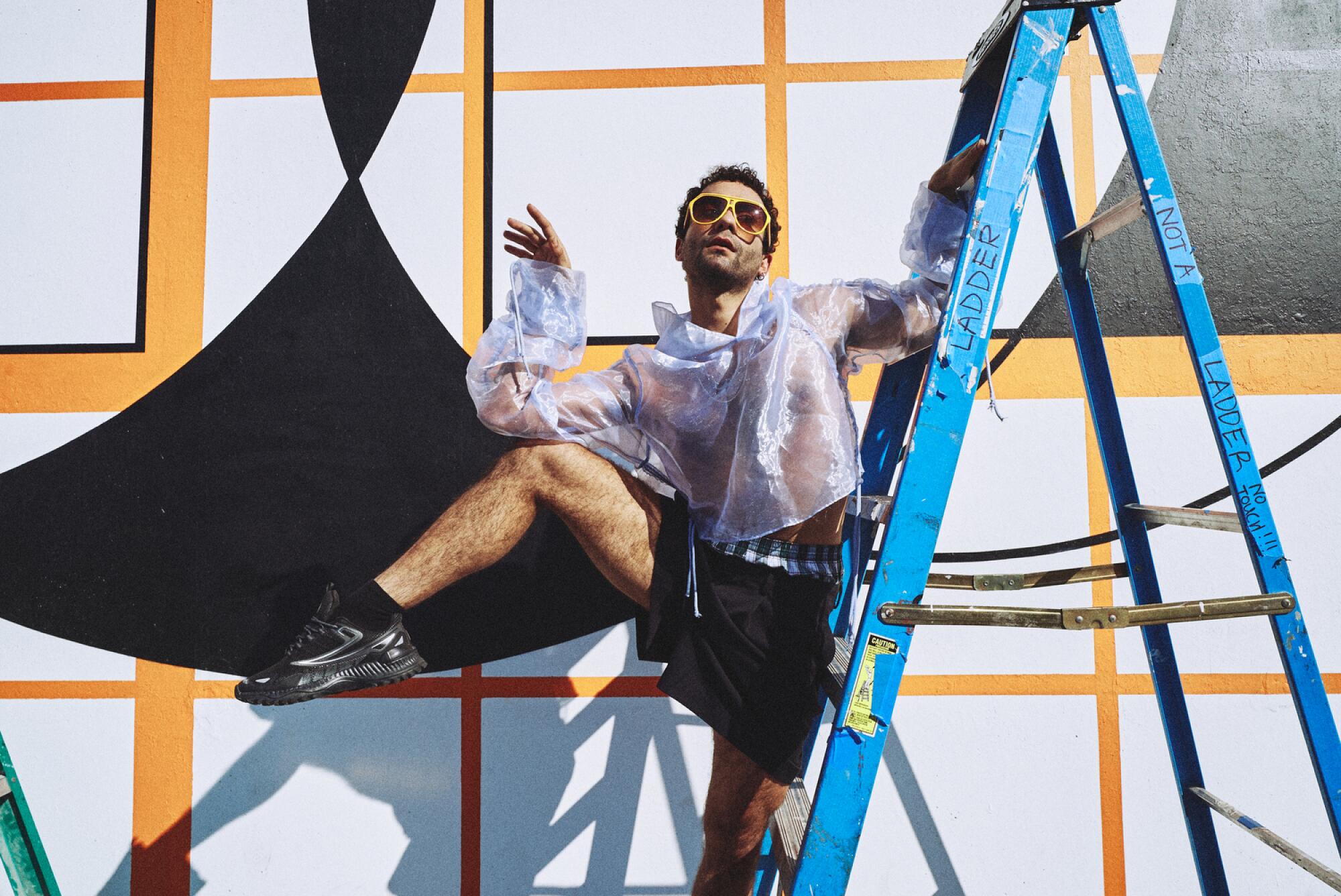 Vinícius Silva wearing lavender crop hoodie by L.A. Roxx and black Papi boxer shorts by Planeta.
