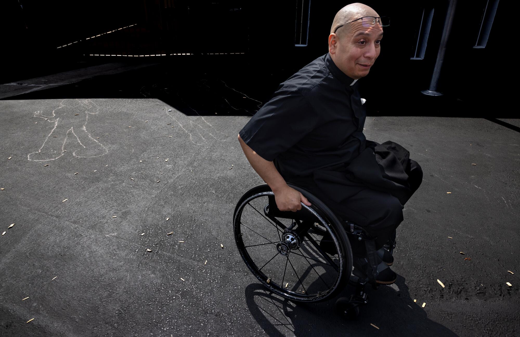 Father Cesar Galan passes by the school yard after leading a Mass at Saint Raymond Catholic Church in Downey.